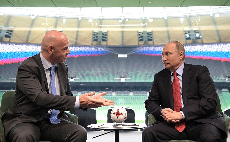 FIFA president Gianni Infantino watching football with a mate.
