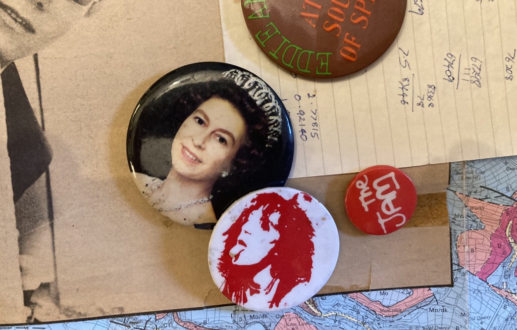 Various pin on badges: Queen Elizabeth II, Patti Smith, The Jam, Eddie & the Hot Rods