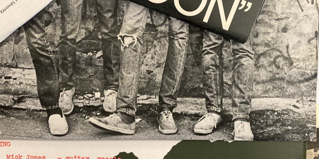 The Ramones first album cover showing  four pairs of jeans & sneakers from the knee down.