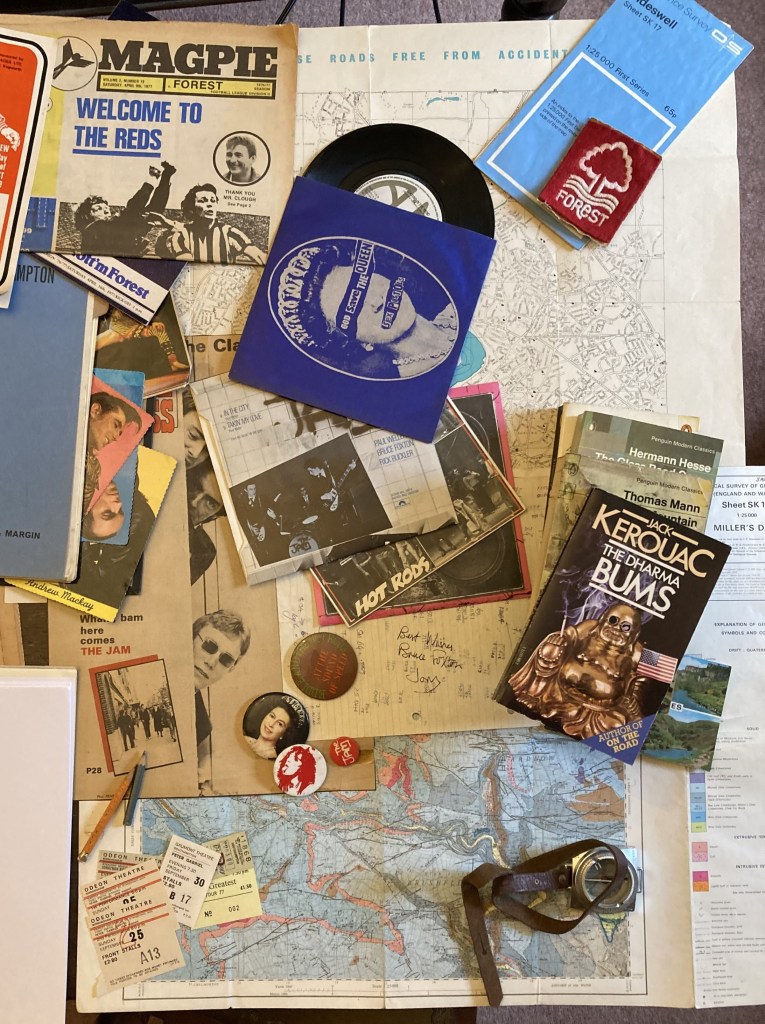 Collage:
Forest programmes; Various singles: God Save the Queen, In the City, Live at the Marquee, Complete Control, Floating in the Wind;  Map of Southampton; Geological Map of Millers Dale; various badges (Jam, Stranglers, Patti Smith, Elizabeth II;  Various tickets (Peter Gabriel, Jonathan Richman, Stiffs);  Dharma Bums paperback; Geological compass.